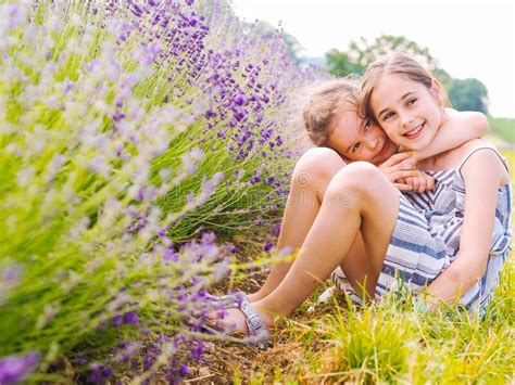 Two Girls Sister Sit Between Lavender Fields In Provence Violet