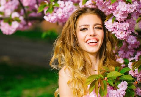 Premium Photo Pretty Woman In Pink Blossom Park Happy Young Girl With Smiling Face Enjoy Spring