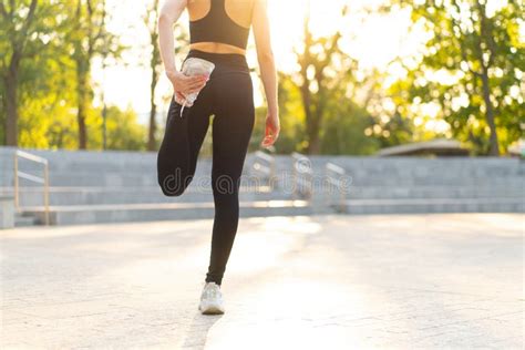 Woman Runner Stretching Legs Before Exercising Summer Park Morning