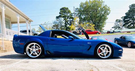 Blue Corvette C5 Parked In Front Of A House
