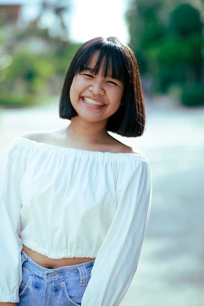 premium photo cheerful asian teenager toothy smiling face with happiness moment