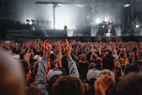 Performance Of A Popular Group The Crowd With Raised Hands Against The