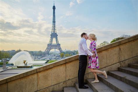 Romantic Couple Kissing Near The Eiffel Tower In Paris France Stock