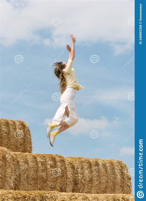 Happy Young Woman Jumps From High Haystack Carefree Girl Has Fun On