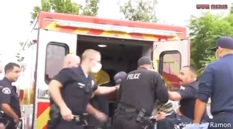 Police Officer Filmed Punching Suspect Handcuffed To A Stretcher The Independent