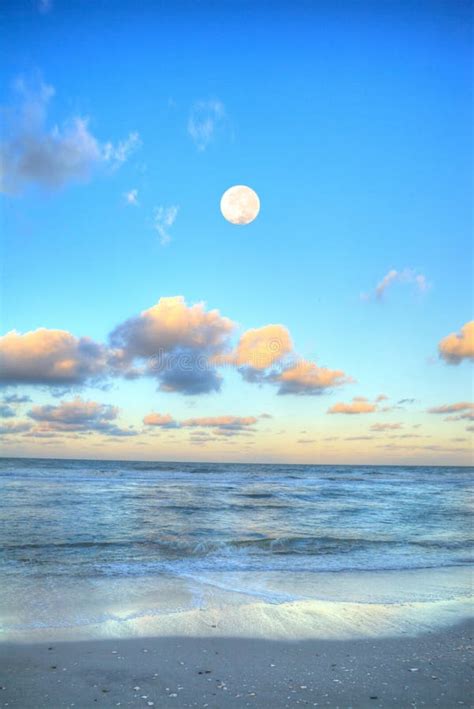 Moonset And Sunset At Crescent Bay Beach In Laguna Beach Stock Photo