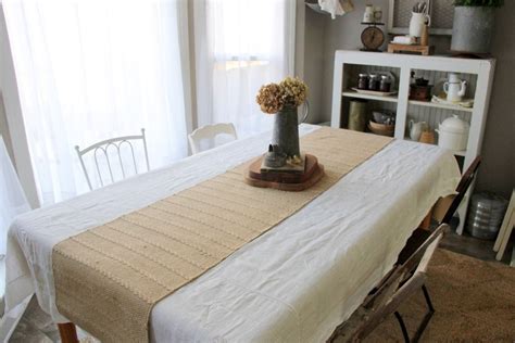 Kitchen Table Dressed In A Vintage White Tablecloth And A Burlap Runner