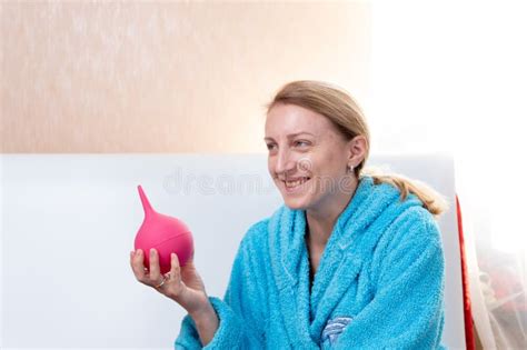 Girl Holds An Enema The Woman Laughs Maliciously Stock Image Image Of Woman Illness