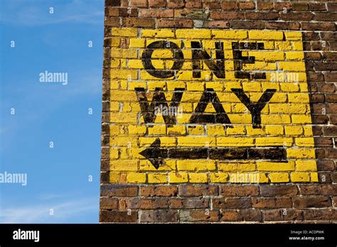 One Way Sign With Arrow Painted On Brick Exterior Wall Stock Photo Alamy