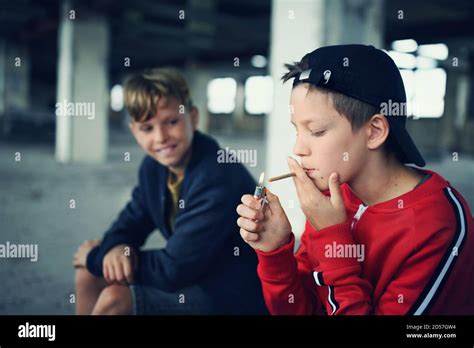 Group Of Teenagers Boys Indoors In Abandoned Building Smoking