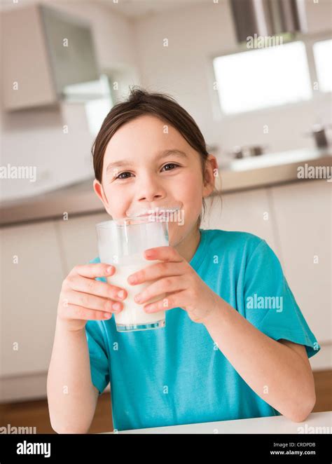 Girl Drinking A Glass Of Milk Stock Photo Alamy