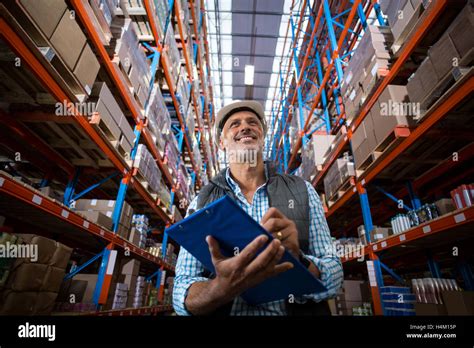 Warehouse worker checking the inventory Stock Photo - Alamy