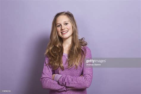 A Smiling Teenage Girl With Arms Crossed Portrait Studio Shot High Res