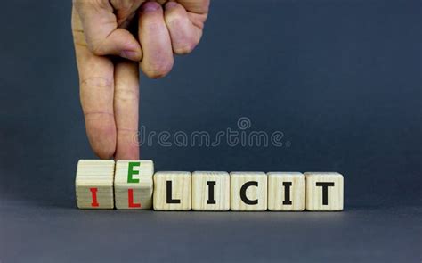 Illicit Or Elicit Symbol Businessman Turns Wooden Cubes And Changes