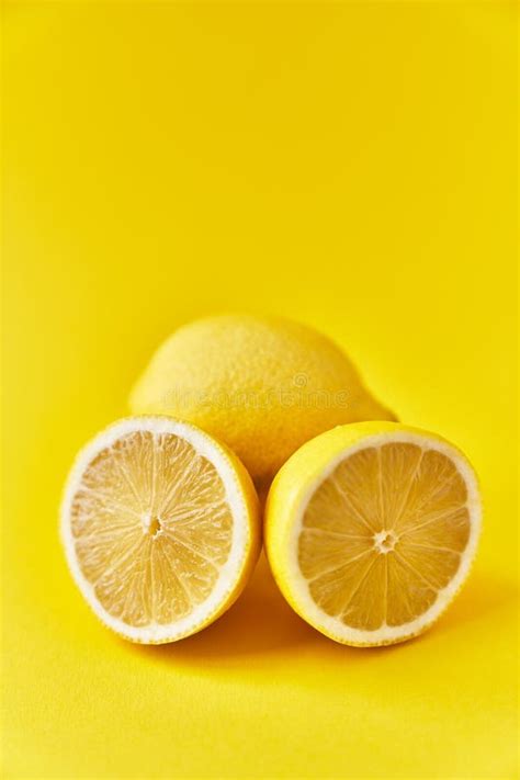 Single And Two Halves Lemon Fruit On A Yellow Background Stock Image