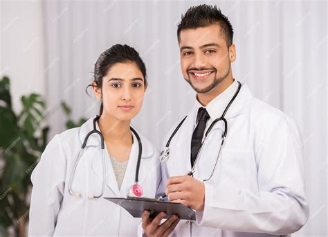 Premium Photo Two Indian Doctors Sitting Working Together
