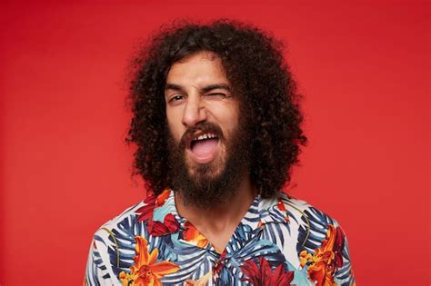 Free Photo Close Up Of Cheerful Young Brunette Curly Man With Beard