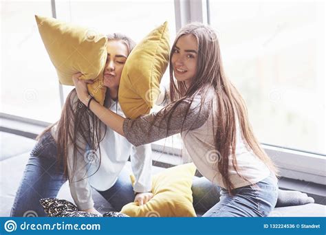 Two Beautiful Young Twins Sisters Spending Time Together With Pillows