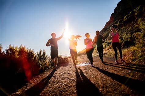 Cheerful Friends Running Outdoors Stock Photo Download Image Now Istock