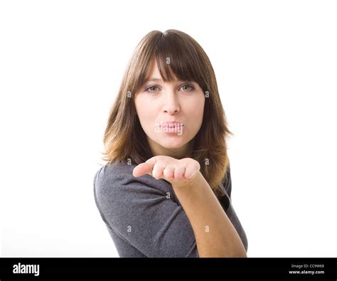 Beautiful Young Woman Blowing A Kiss Isolated On A White Background