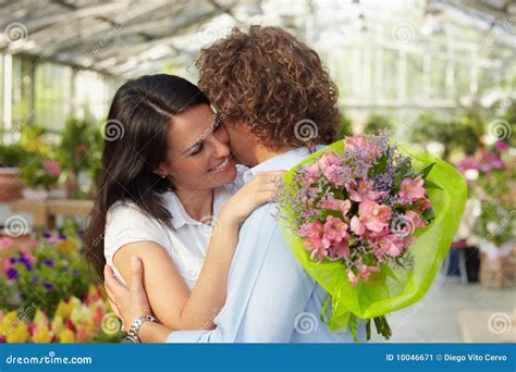 couple hugging in flower nursery stock image image of flower t 10046671