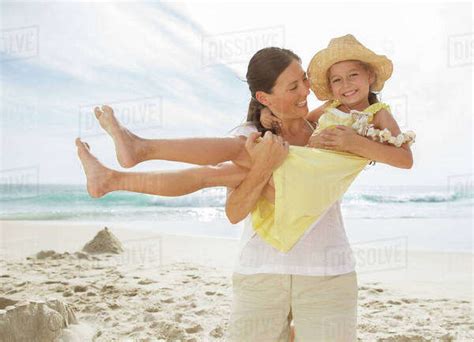 Mother Holding Daughter On Beach Stock Photo Dissolve