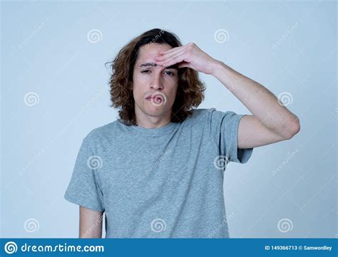 Portrait Of Sad Teenager Man In Pain Having Headache And Migraines
