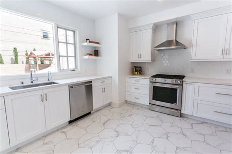 Experienced and creative kitchen designers. Beautiful, clean white kitchen with carrara marble ...