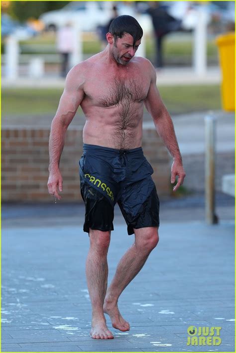 Hugh Jackman Runs Shirtless On The Beach With His Ripped Muscles On