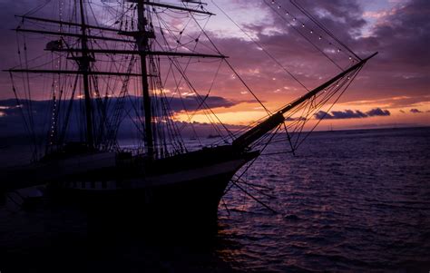 Silhouette Of Ship On Body Of Water During Sunset Hd Wallpaper