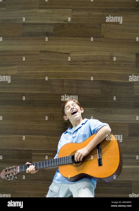 Boy Playing Guitar And Singing Stock Photo Alamy