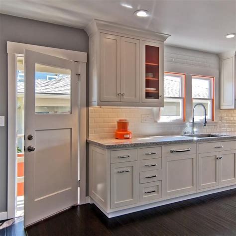 Timeless White Galley Kitchen With Bold Orange Accents Hgtv Kitchen