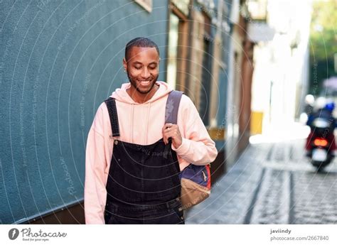Young Black Man Walking Smiling Down The Street A Royalty Free Stock