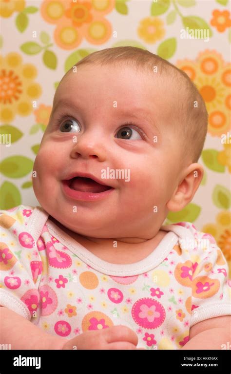 A Happy Six Month Old Baby Posing In Floral Patterns Stock Photo Alamy