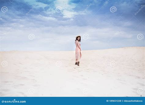 Girl In Desert Walk With Dark Hair Sand And Blu Sky Stock Photo Image