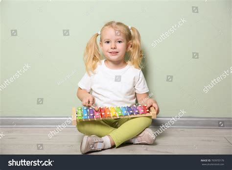 Cute Little Girl Playing Xylophone Near Stock Photo 793970179
