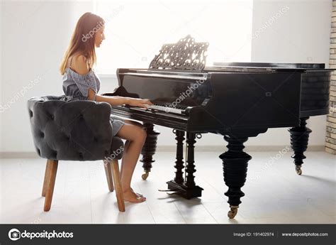 Woman Playing Piano Home Stock Photo By ©belchonock 191402974