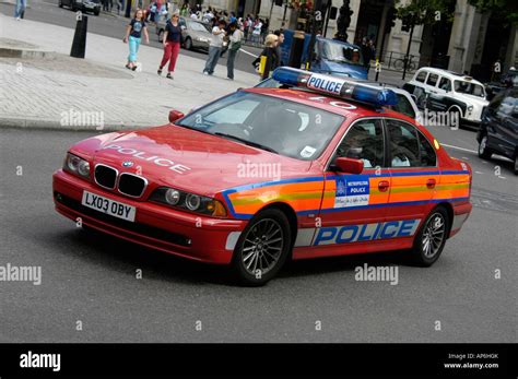 Red Bmw Metropolitan Police Car Driving Through The City Of London