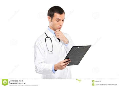 Pensive Medical Doctor Looking At Clipboard Stock Photography Image