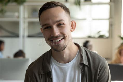 Headshot Of Smiling Male Employee Talk On Video Call Stock Photo