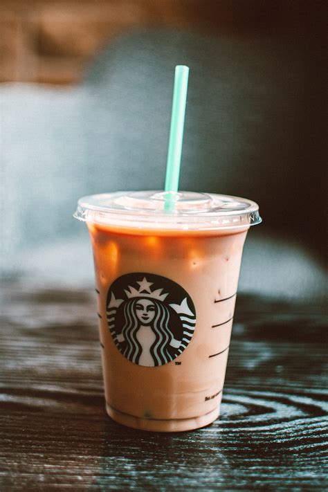 Starbucks Cold Beverage On Table With Straw · Free Stock Photo