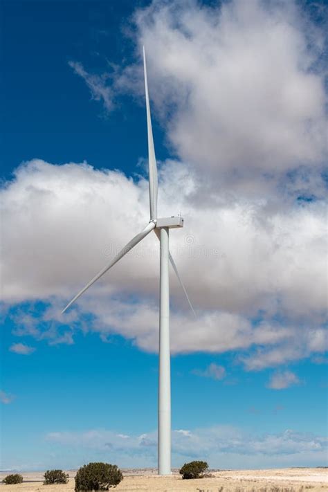 Wind Turbine Under An Idyllic Blue Sky With Fluffy White Clouds Stock