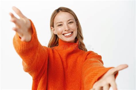 Portrait Of Beautiful Blond Girl Smiling Reaching Hands Forward Stretching Arms To Hold