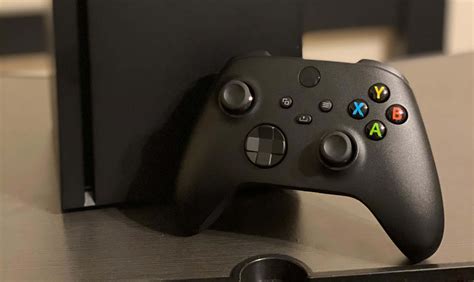 Download A Black Xbox One Console Is Sitting On A Table