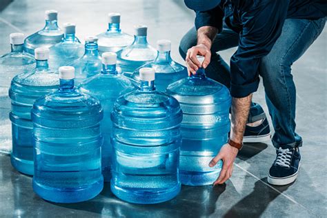 Man Delivering Large Bottles With Drinking Water Stock Photo Download