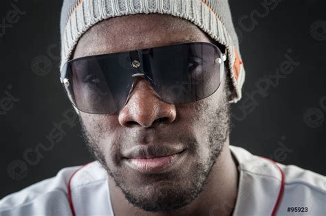 Confident Black Man Close Up Portrait With Sunglasses Against Dark