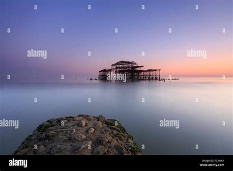 The Ruins Of The West Pier In Brighton At Sunset And A Low Spring Tide