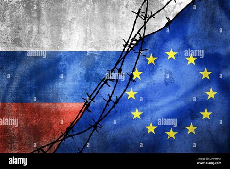 Grunge Flags Of Russia And European Union Divided By Barb Wire