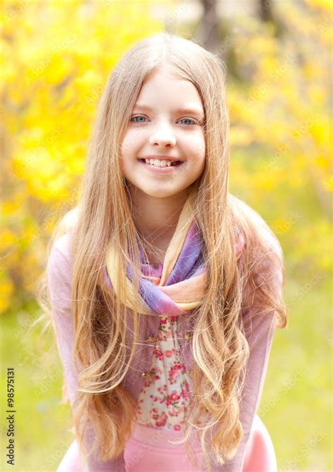 Happy Teenager Girl 13 15 Year Old Standing Over Yellow Nature Background Looking At Camera