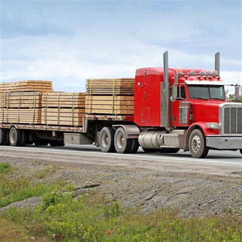 Semi Flatbed Truck Hauling A Load Of Lumber To A Construction Site
